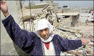 Palestinian woman among debris in Jenin