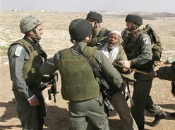 Border Police officers restraining a Bedouin man while his house is destroyed south of the West Bank city of Hebron on Wednesday Feb 14, 2007. 